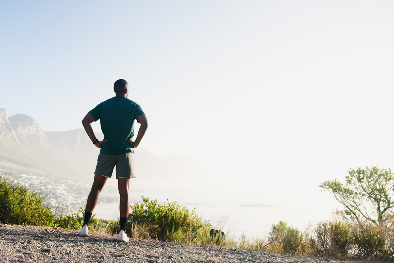 Homme au sommet du coline se ressource pour avoir le mental.
